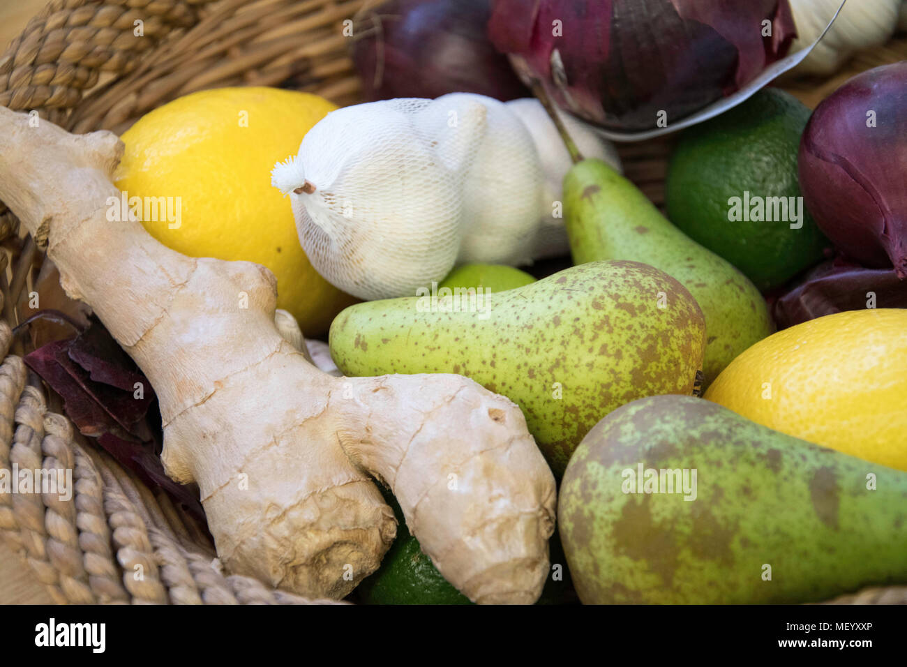mix fruits and vegetables basked including pears lemons and ginger Stock Photo