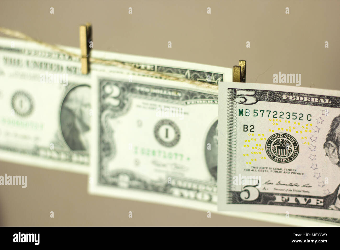 dollars are hanging on the clothesline clothespins attached Stock Photo