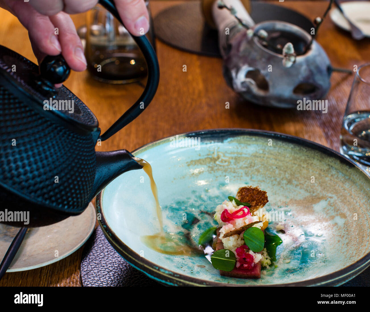 Stylish pouring: here comes barley miso brew from the teapot. Miso Dish by German Michelin Star Chef Heiko Lacher. Restaurant Anima in Tuttlingen, Germany Stock Photo