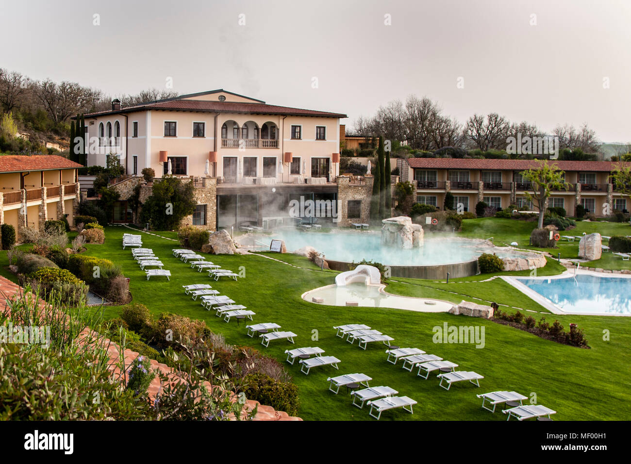 Hotel Adler Thermae, Bagno Vignoni, Tuscany with thermal pool, Tuscany, Val d'orcia Italy, UNESCO World Heritage. The main house in the style of a Roman villa. On both sides spread the 90 hotel rooms, all with private terrace or balcony and views of the countryside Stock Photo