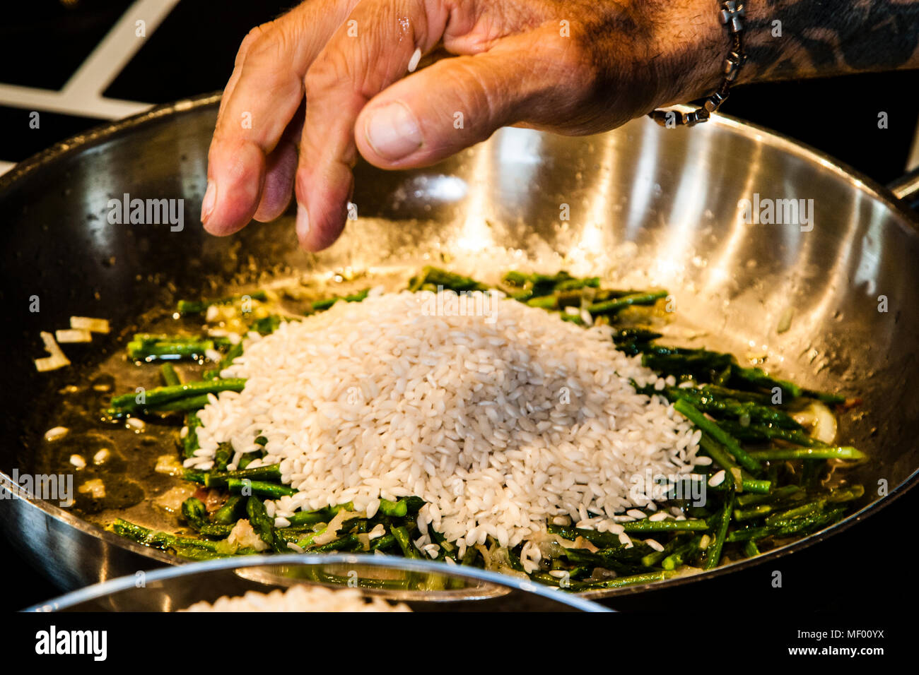Rule of thumb: two handfuls of rice per person. Foraging the wild asparagus means collecting a delicacy in Tuscany, Italy. It is precious and rare like truffles Stock Photo