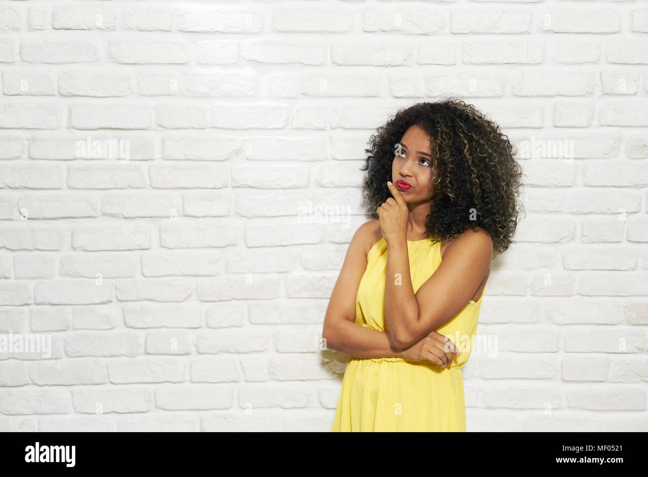 Facial Expressions Of Young Black Woman On Brick Wall Stock Photo