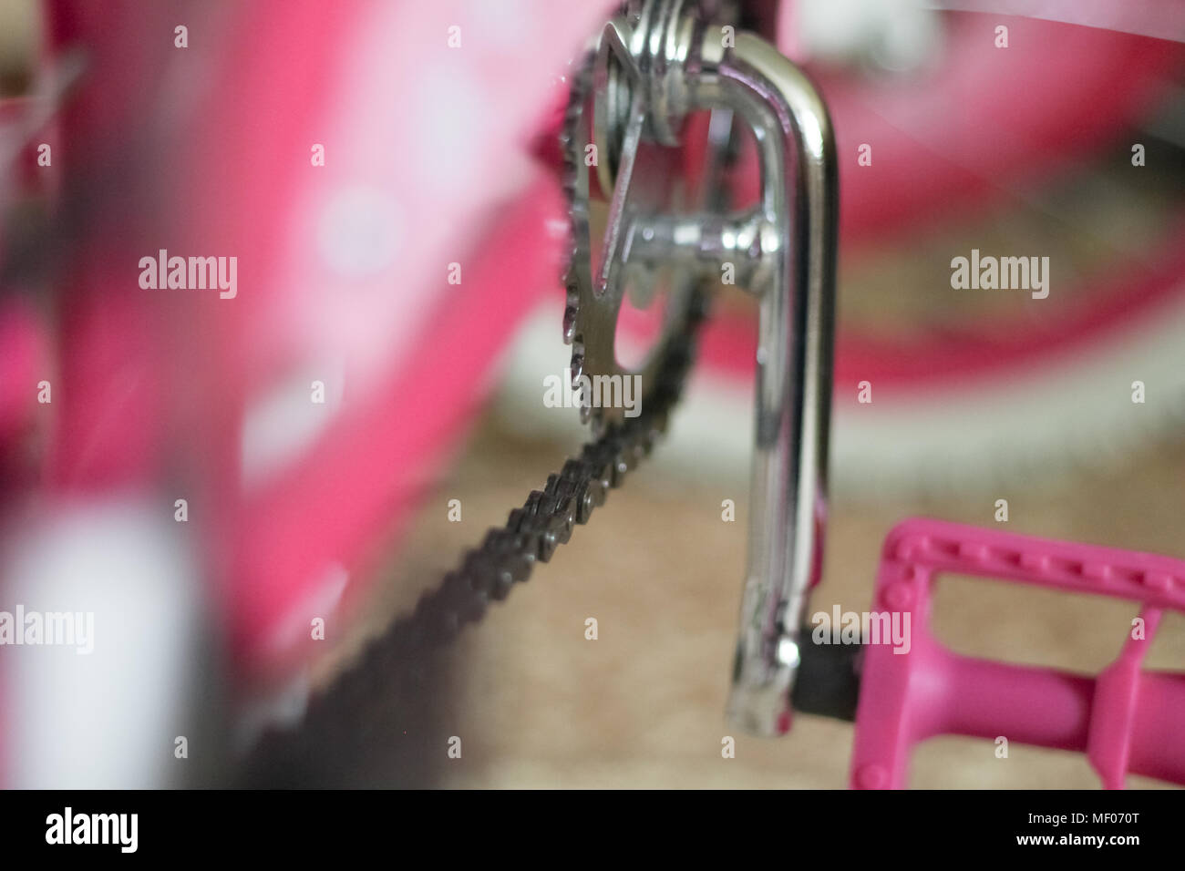 pink child's bicycle closeup with white wheels Stock Photo