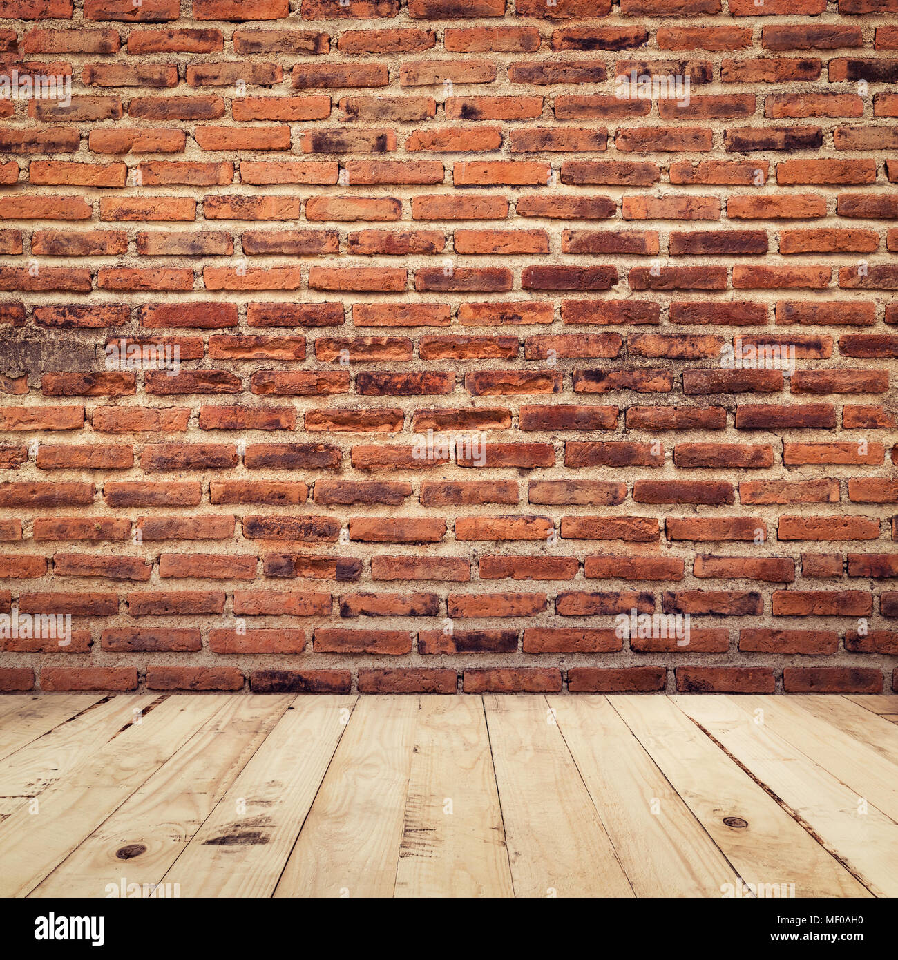old brick and wood floor perspective interior room background with vintage toned. Stock Photo