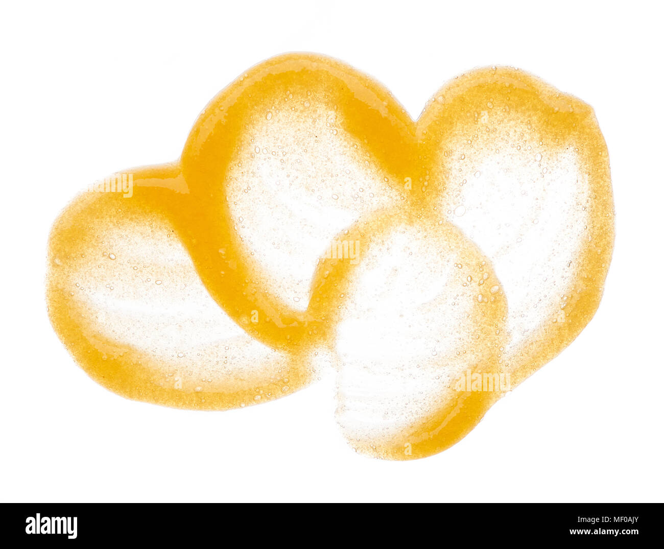 Smear of orange sugar scrub for body and lips are isolded on a white ...