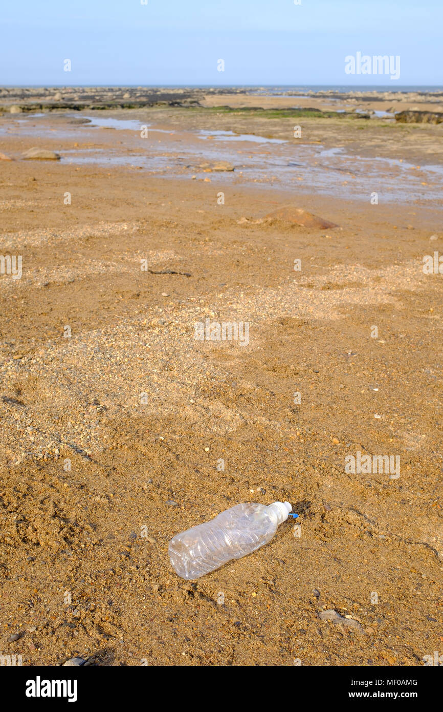 Plastic drinks bottle discarded on a British beach. Stock Photo