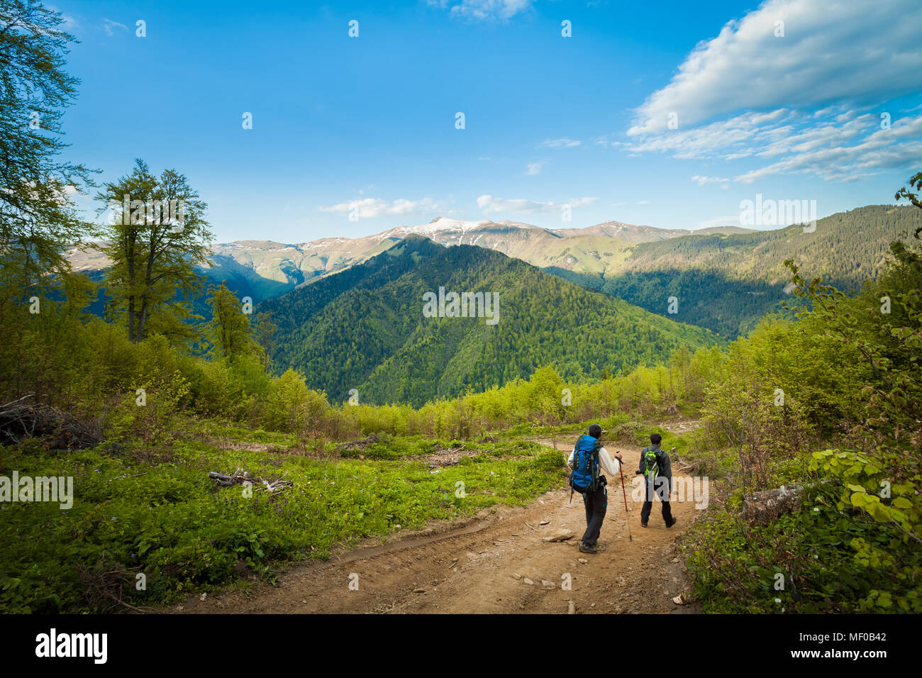 Two hikers climbing down the mountain Stock Photo - Alamy
