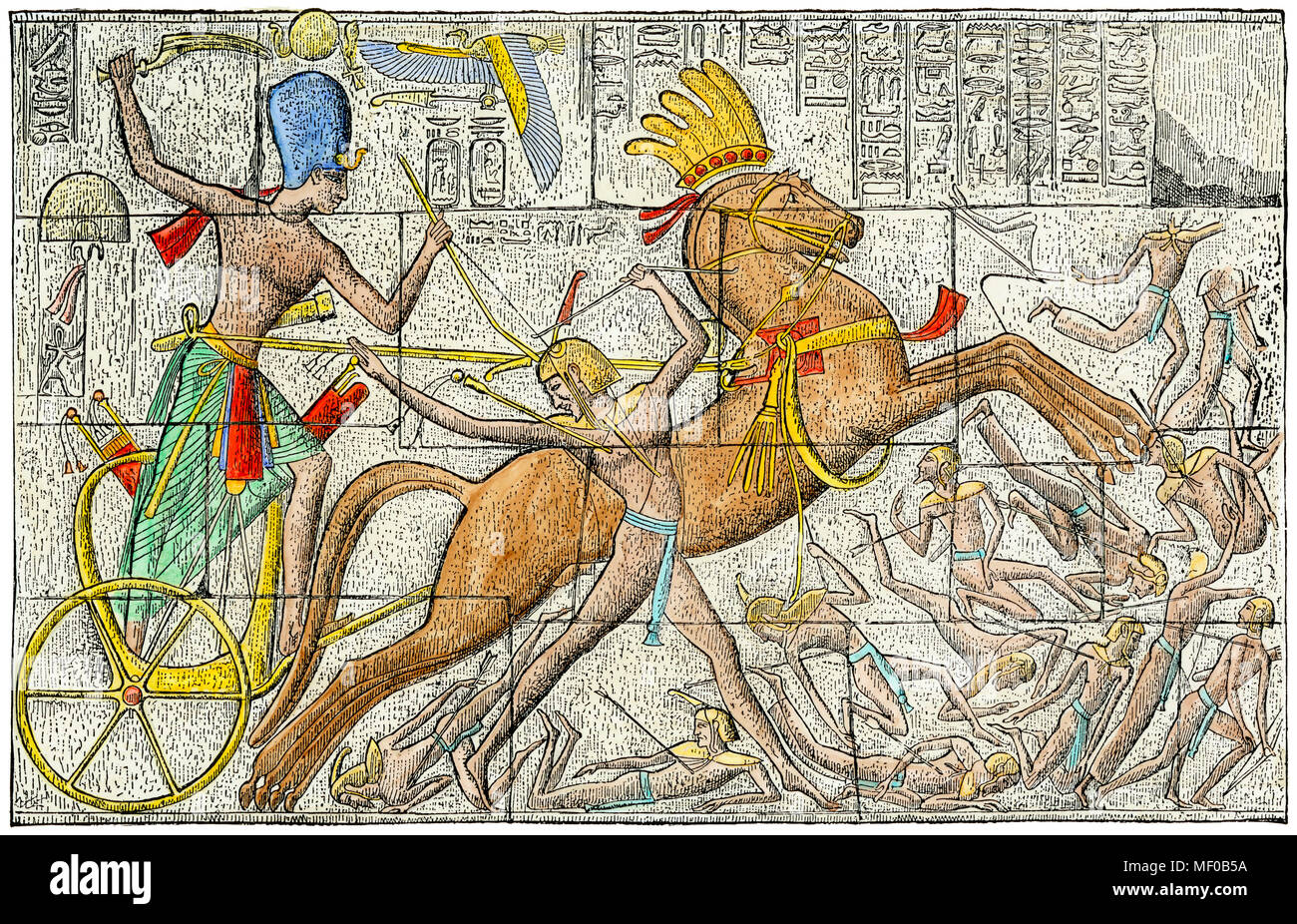 Pharaoh driving a chariot in battle, ancient Egypt. Hand-colored engraving of a bas-relief Stock Photo
