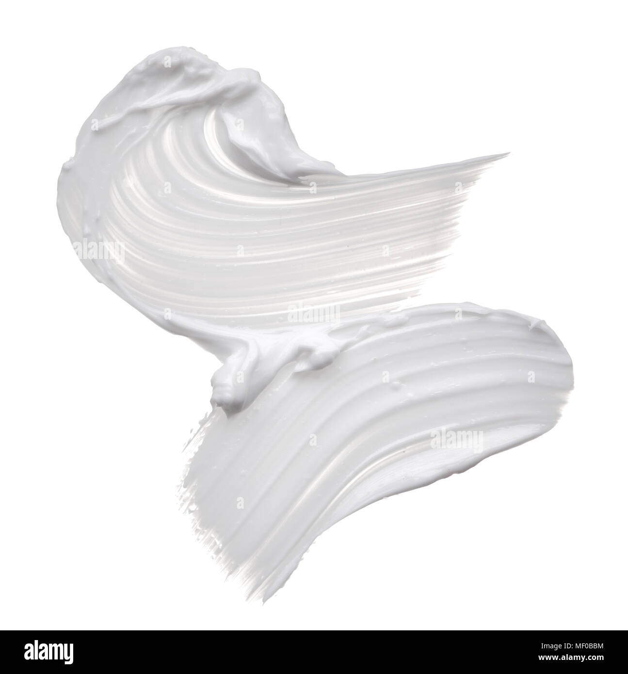 White ?reamy texture isolated on white background. Smear of face cream