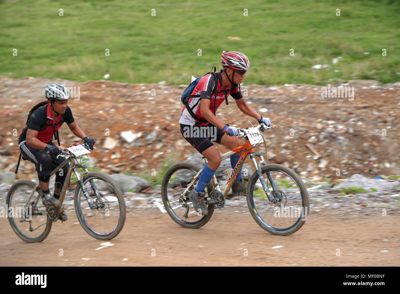 Competitive Bike Riders Panning shot of biker struggling uphill during PCC Specialized ...
