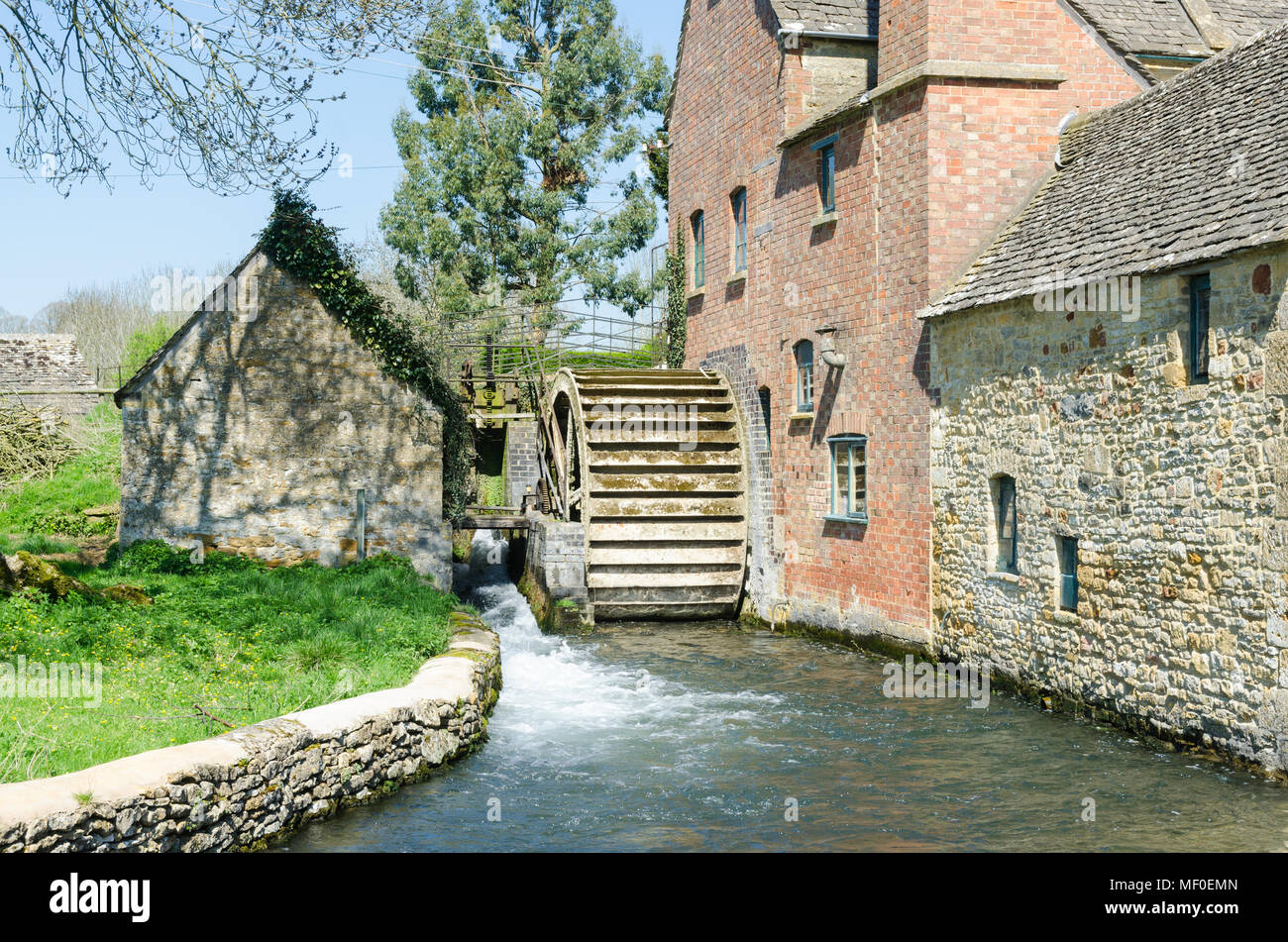 Old water mill on the River Eye in the pretty Cotswold village of Lower