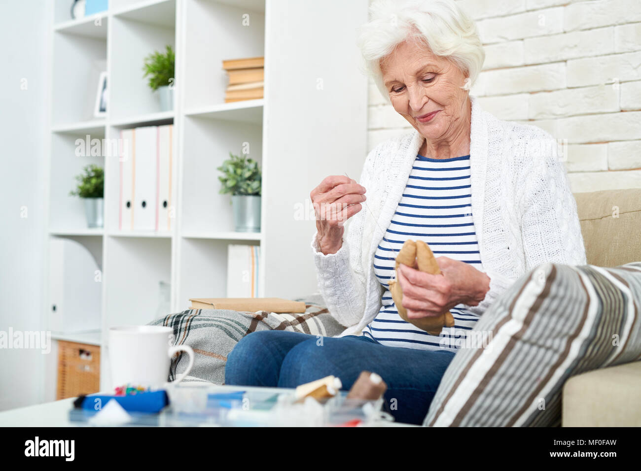 Woman sewing toy hi-res stock photography and images - Alamy