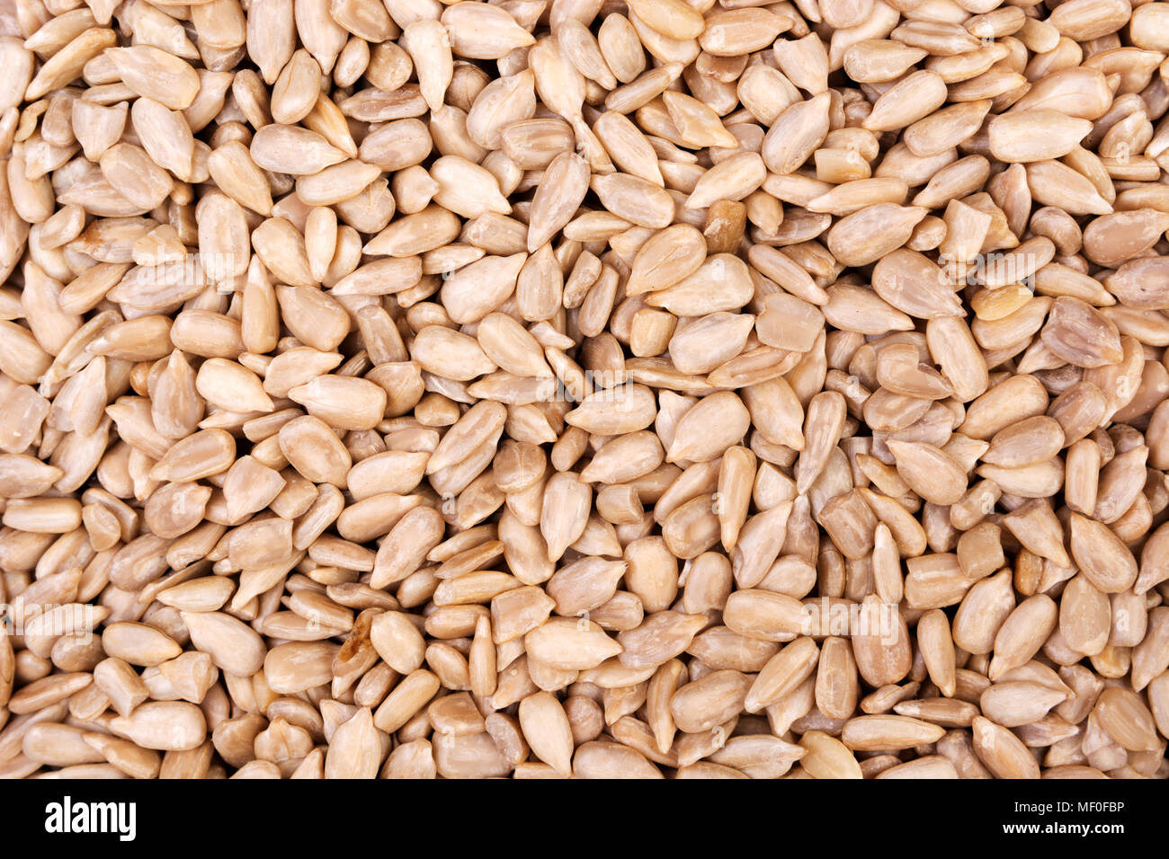 Peeled sunflower seeds background. View from above Stock Photo