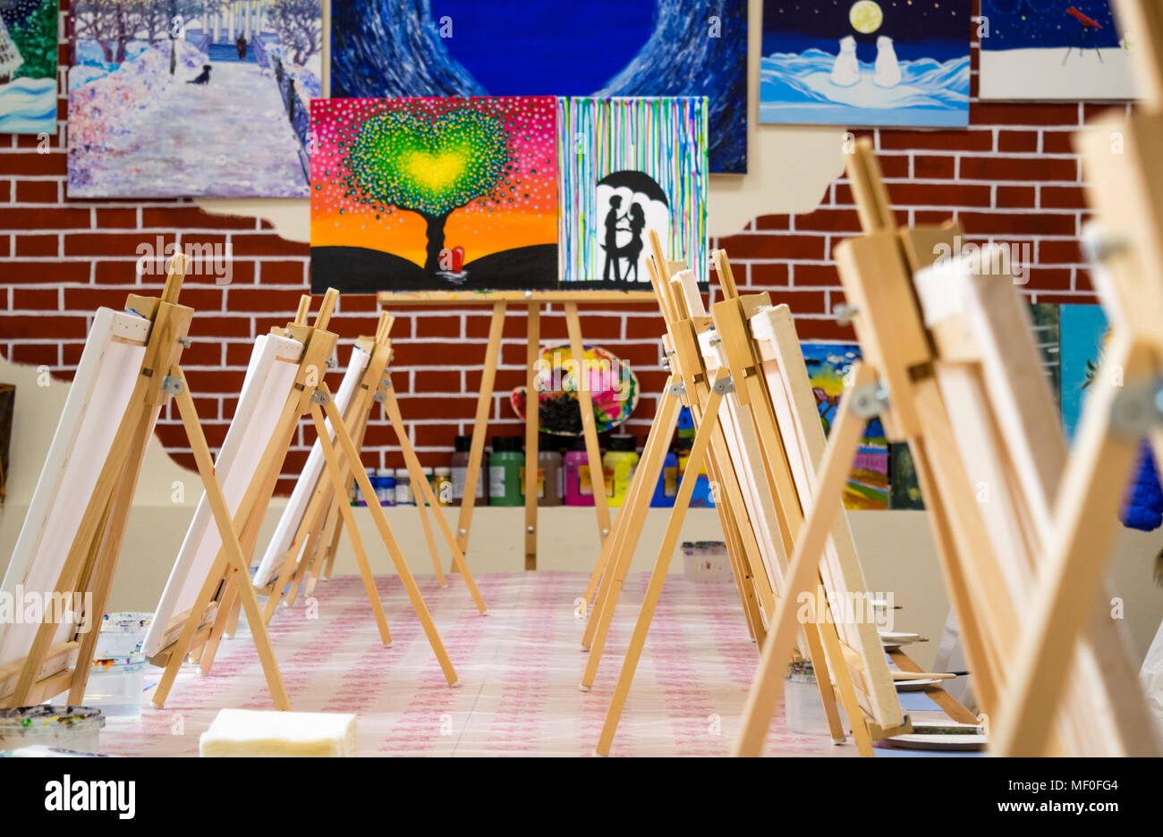 KIROV, RUSSIA - JUNE 23, 2017: Canvases standing in a row on the long table in the local art studio in preparation for the artistic masterclass Stock Photo