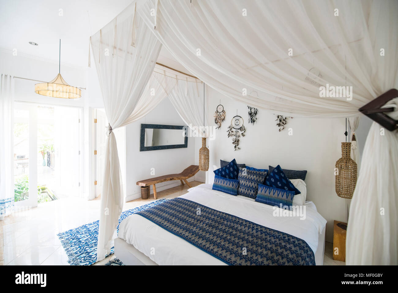 Cozy airy bedroom with blue pillows Stock Photo
