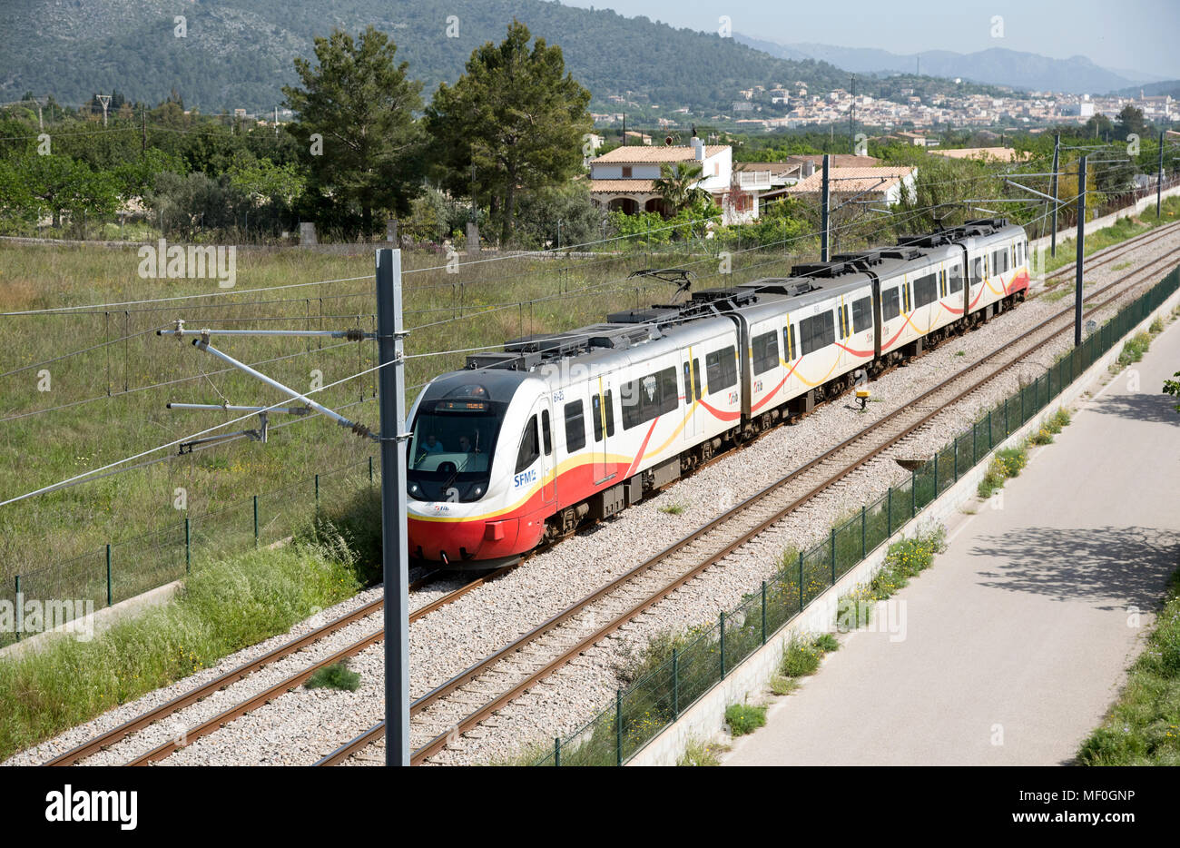 Binissalem in the central plain, Majorca, Balearic Islands, Spain. Modern electric passenger train passing through countryside surrounding Binissalem Stock Photo