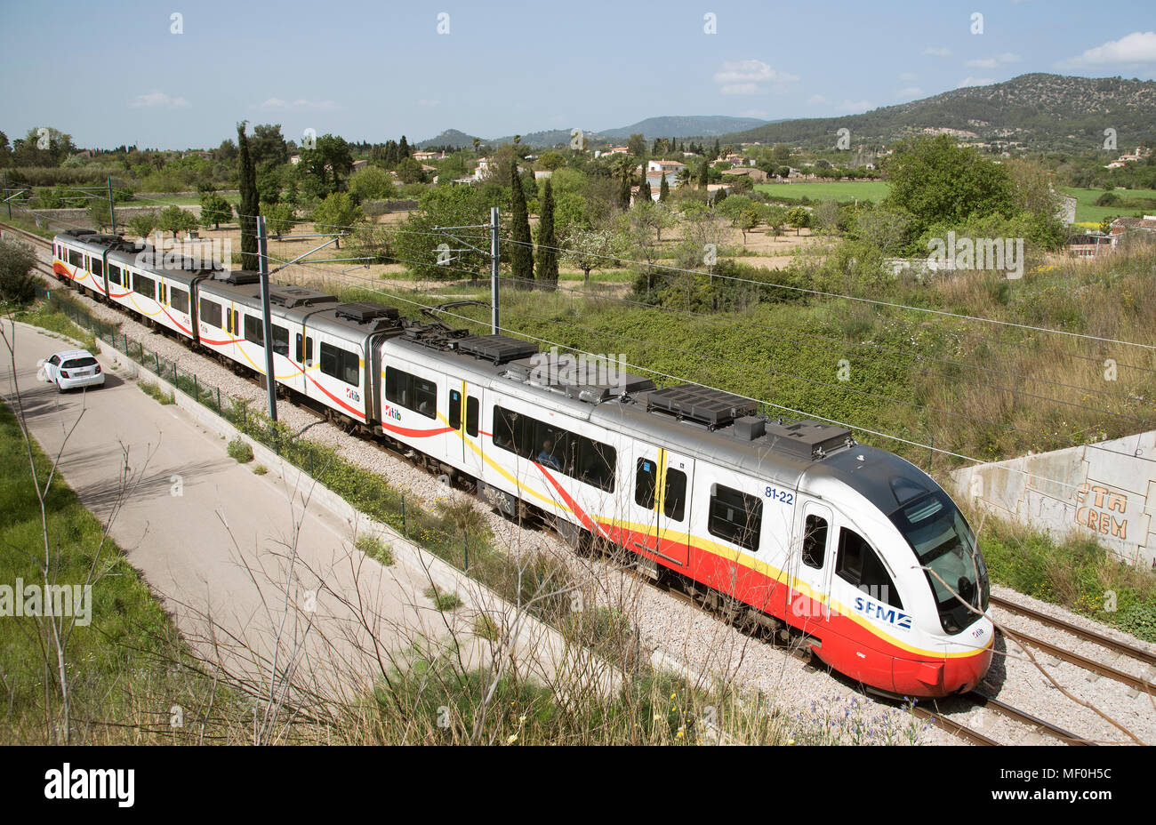 Binissalem in the central plain, Majorca, Balearic Islands, Spain. Modern electric passenger train passing through countryside surrounding Binissalem Stock Photo