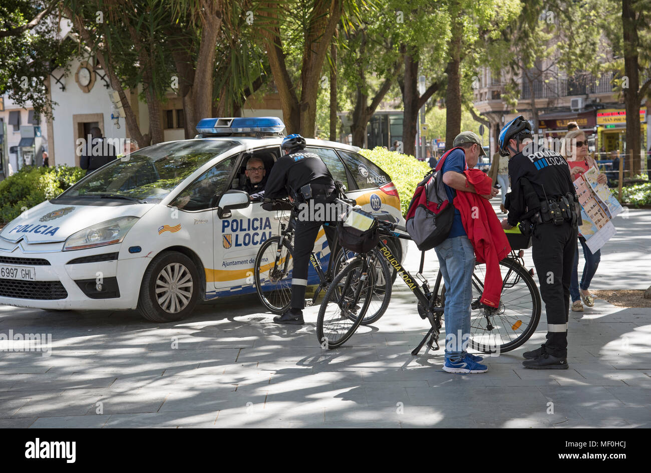 Palma, Majorca, Spain. 2018. Local police officers assist tourist in the centre of the city Stock Photo