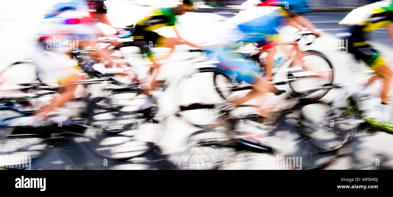 Abstract arty background : motion blur of young bicycle racers competing on city streets Stock Photo