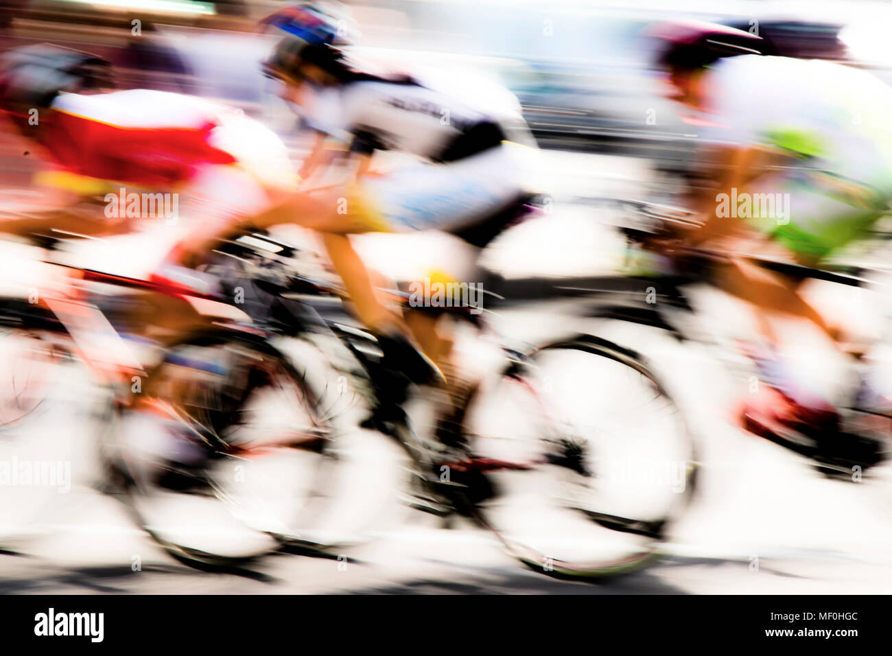 Abstract arty background : motion blur of three young bicycle racers competing on city streets Stock Photo