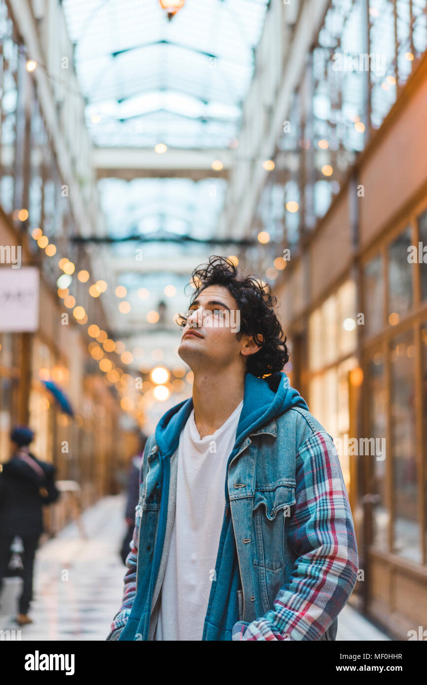 Portrait of smiling young man in shopping centre Stock Photo - Alamy