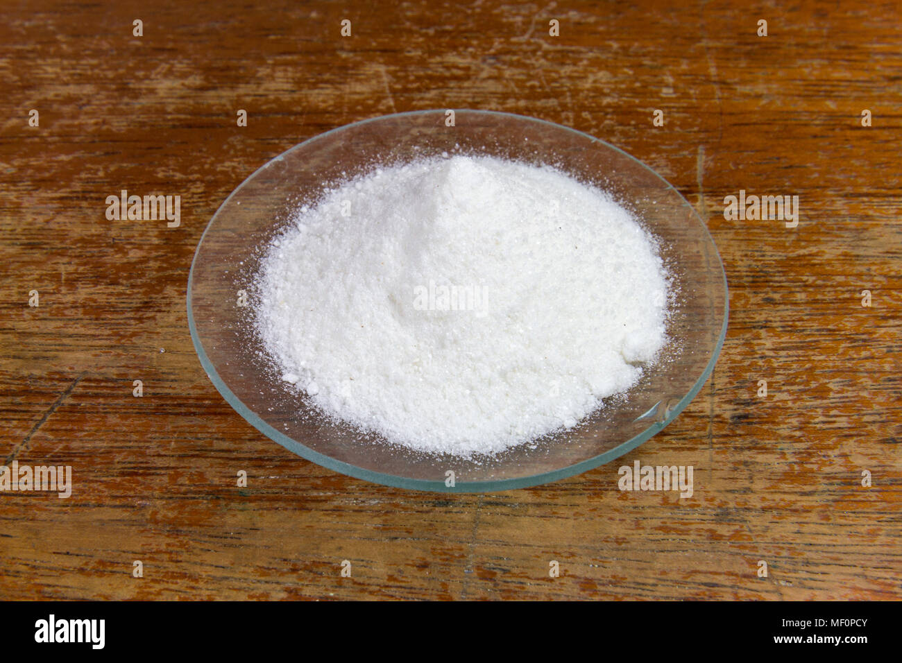 A watch glass of ascorbic acid (vitamin C) powder as used in a UK secondary/high school. Stock Photo
