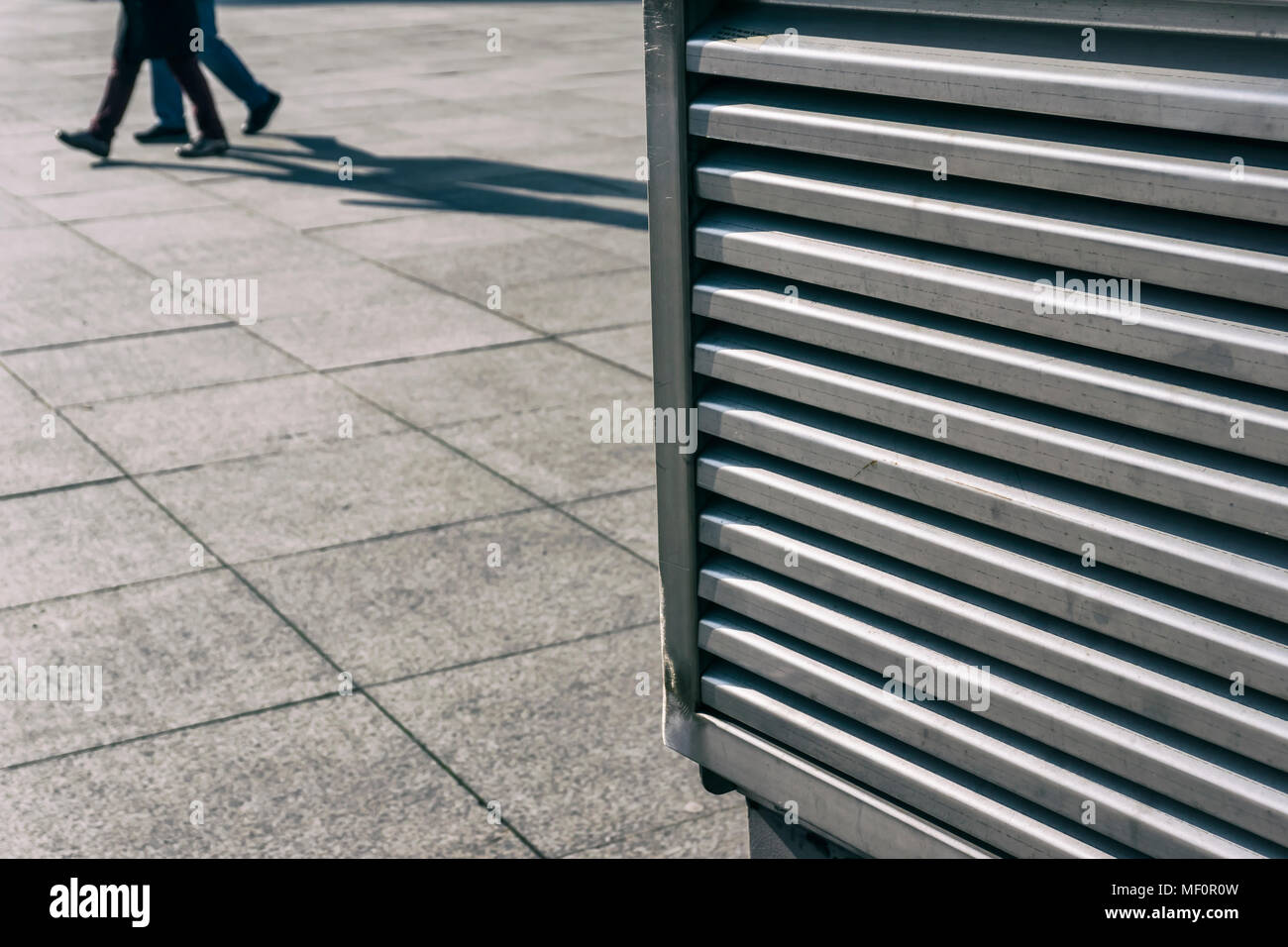 Close-up of subway ventilation system with passers-by in background Stock Photo