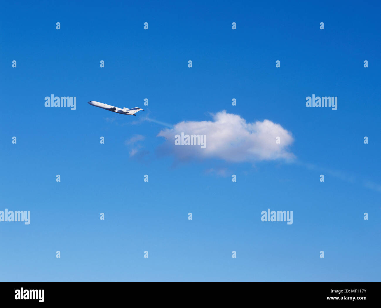 Airplane passing through cloud Stock Photo