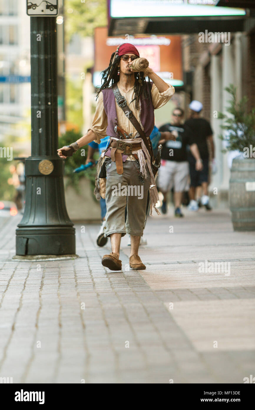 A man dressed like Captain Jack Sparrow from the Pirates of the Caribbean movies, walks before the Dragon Con Parade on September 5, 2015 in Atlanta. Stock Photo