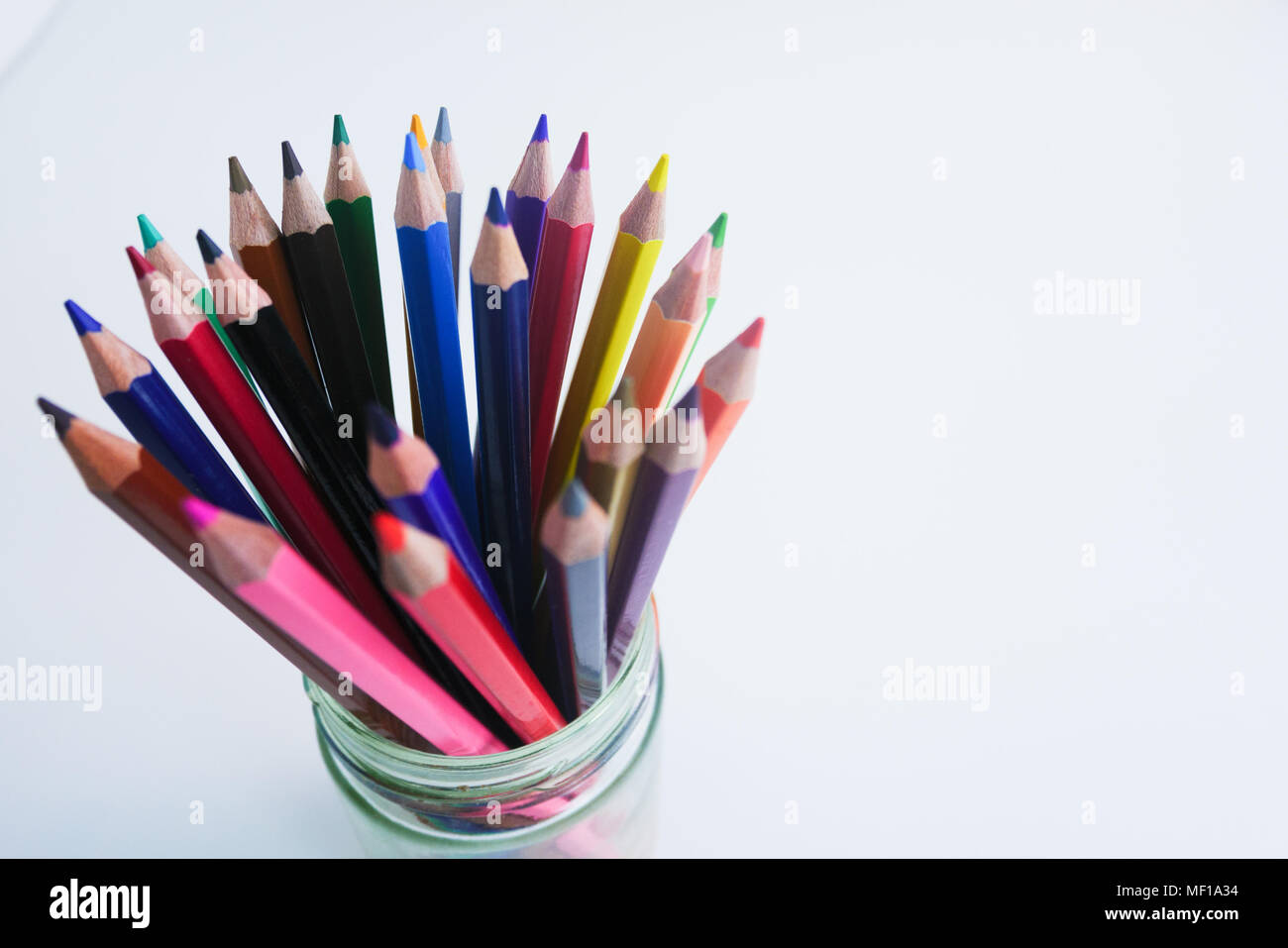 Top view of colored pencils with shavings and pencil sharpener over white  background. top view Stock Photo - Alamy