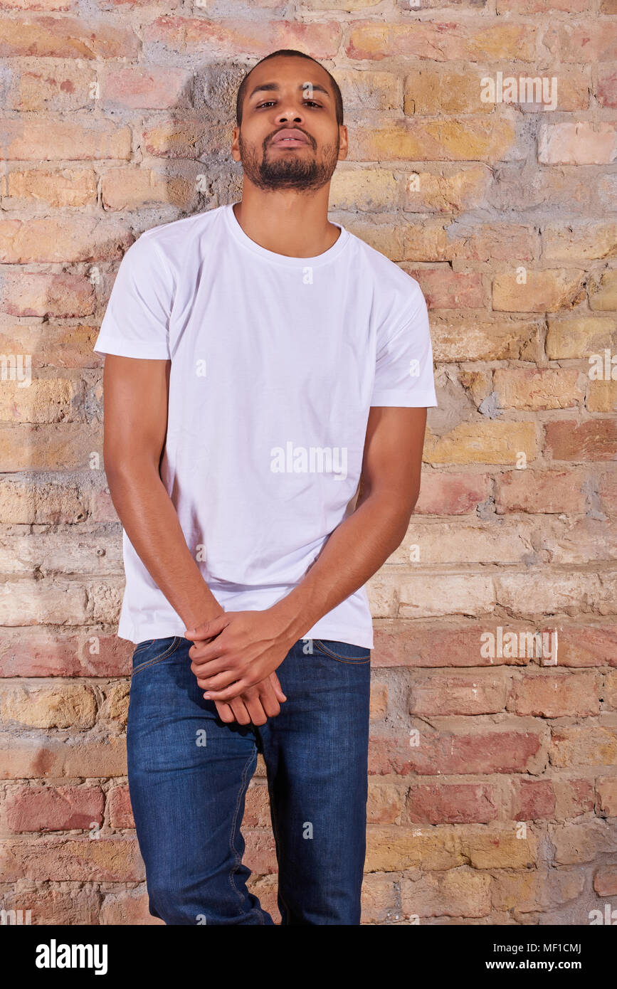 Portrait Of A Serious Handsome Young Man In A White Tshirt And Blue Jeans Stock Photo Alamy Portrait Of A Serious Handsome Young Man In A White Tshirt And Blue Jeans Stock Photo Alamy