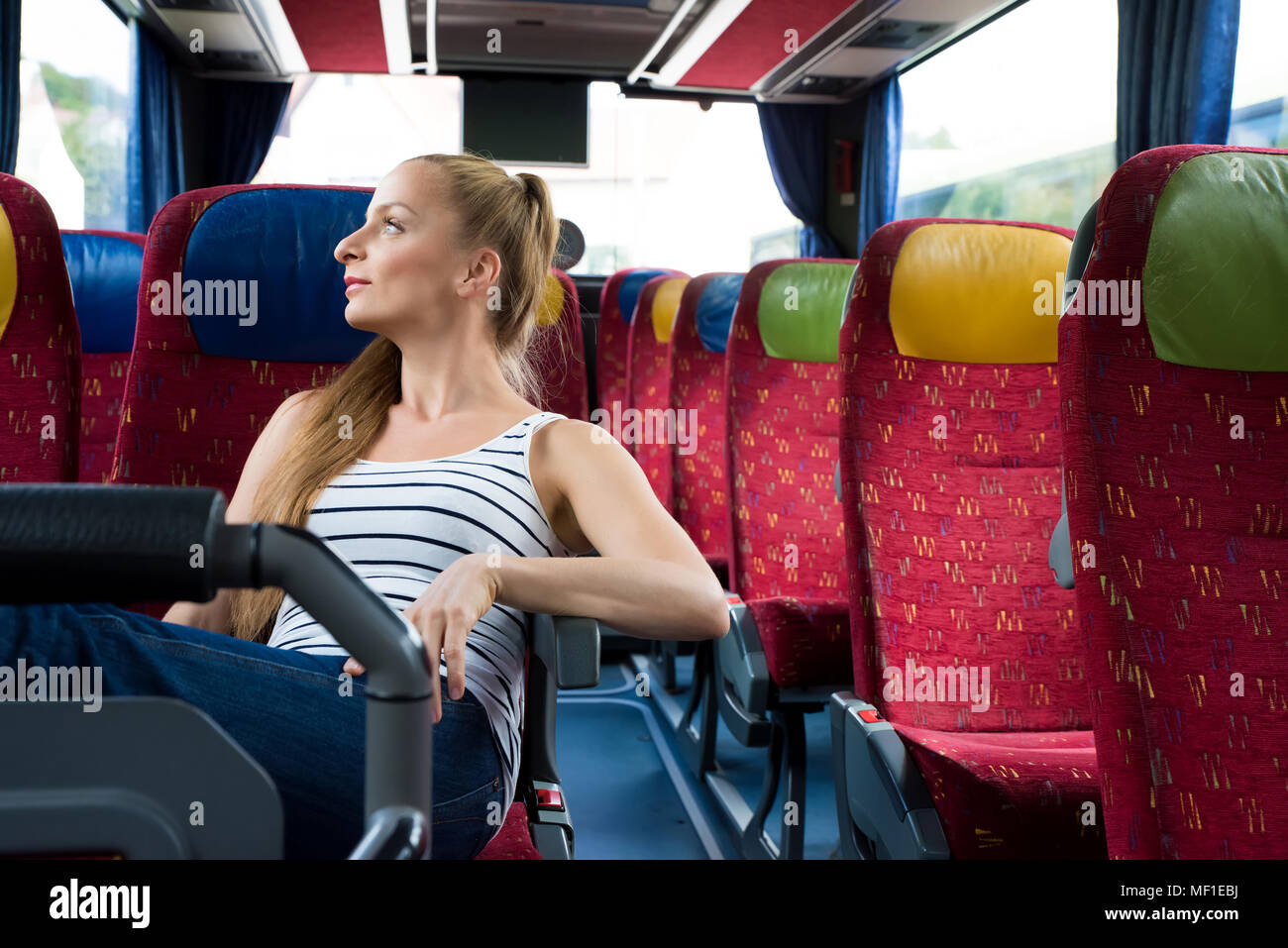 A young woman sitting comfortably on the bus Stock Photo Alamy