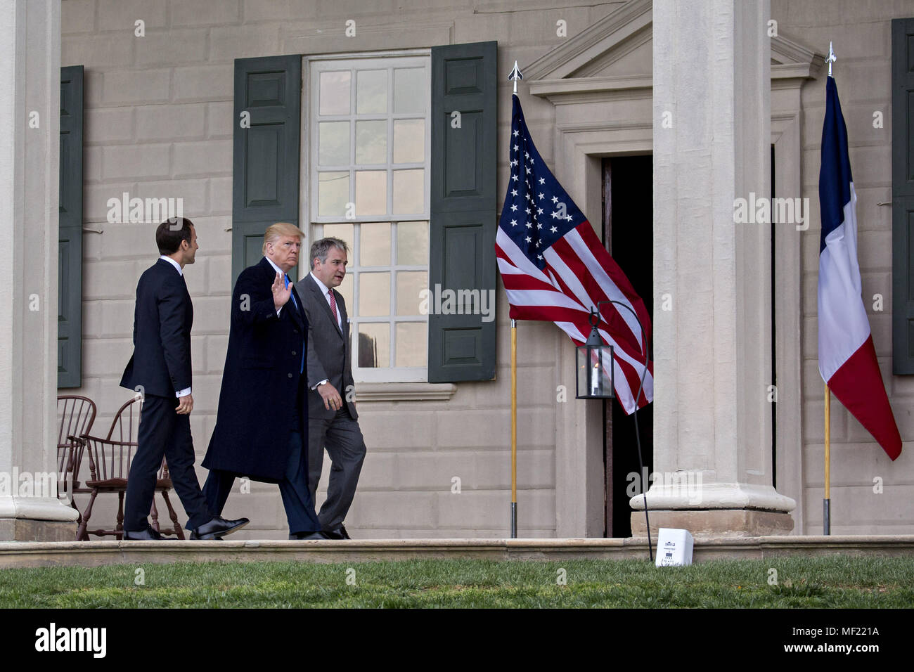 Mount Vernon, Virginia, USA. 23rd Apr, 2018. U.S. President Donald Trump, center, waves next to Emmanuel Macron, France's president, left, and Doug Bradburn, president and chief executive officer of George Washington's Mount Vernon, while touring outside the Mansion at the Mount Vernon estate of first U.S. President George Washington in Mount Vernon, Virginia, U.S., on Monday, April 23, 2018. As Macron arrives for the first state visit of Trump's presidency, the U.S. leader is threatening to upend the global trading system with tariffs on China, maybe Europe too. Credit Stock Photo