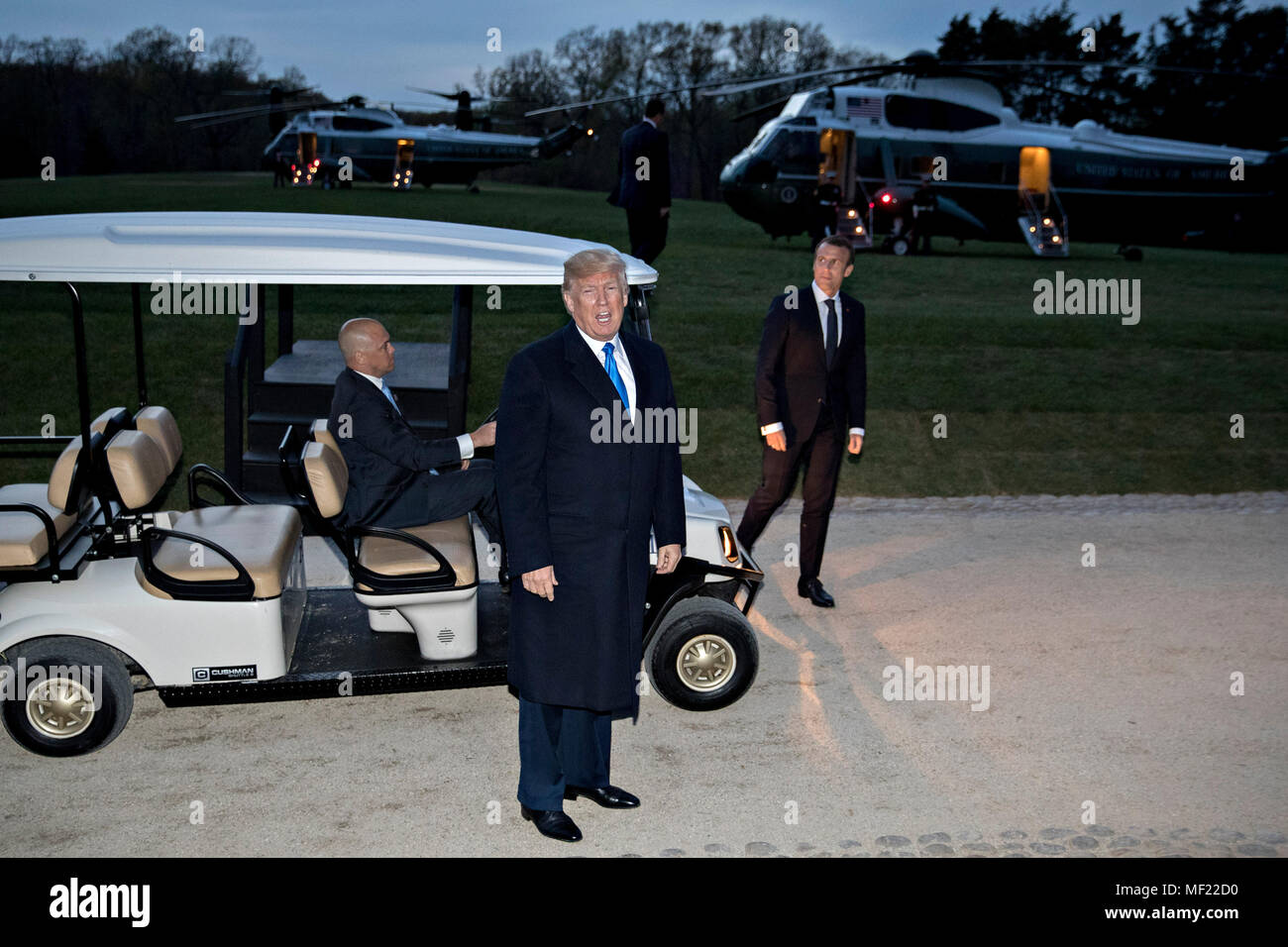 U.S. President Donald Trump speaks to members of the media after stepping out of a golf cart following a dinner with Emmanuel Macron, France's president, right, at the Mount Vernon estate of first U.S. President George Washington in Mount Vernon, Virginia, U.S., on Monday, April 23, 2018. As Macron arrives for the first state visit of Trump's presidency, the U.S. leader is threatening to upend the global trading system with tariffs on China, maybe Europe too. Credit: Andrew Harrer/Pool via CNP Photo via Credit: Newscom/Alamy Live News Stock Photo