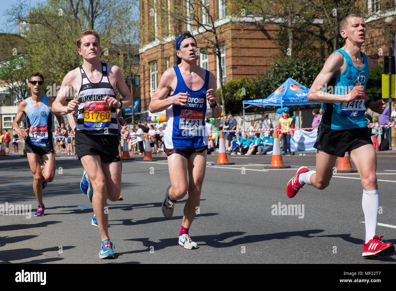 London, UK. 22nd April, 2018. Roger Poolman (l) of Highgate Harriers, Michael Channing (c) of Bedford and County AC and Robert Latala (r) of Ashford and District RRC compete in the 2018 Virgin Money London Marathon. The 38th edition of the race was the hottest on record with a temperature of 24.1C recorded in St James’s Park. Stock Photo
