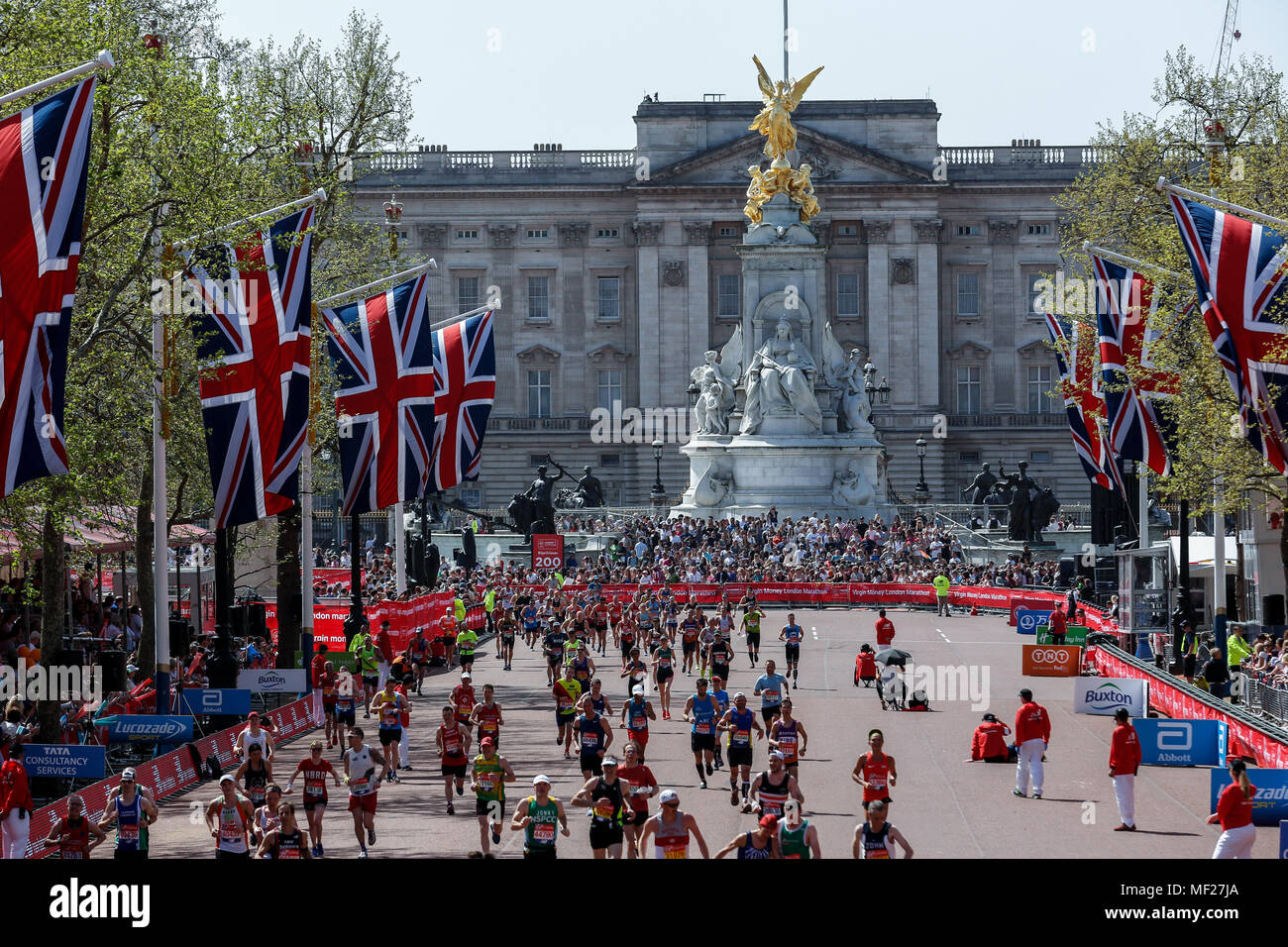 Mass Race runners approach the finish at The Mall in front of Buckingham Palace during the Virgin Money London Marathon in London, England on April 22, 2018. 41 thousand people participated in the marathon. Stock Photo