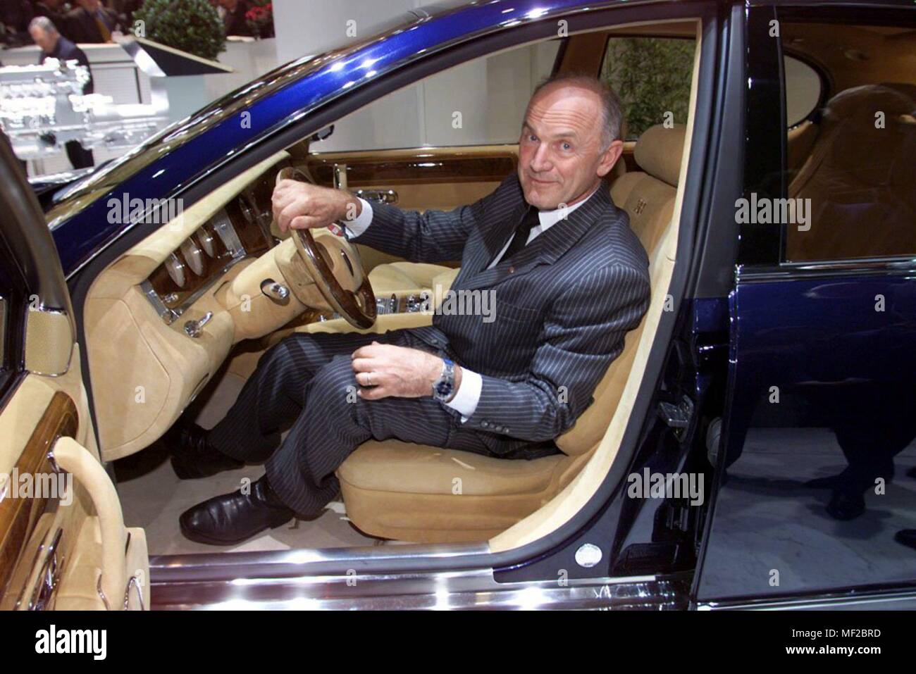 VW boss Ferdinand Piech climbs on 9.3.1999 at the Geneva Motor Show from a Bugatti EB 218 with 555 hp. The study follows in design and technology the already presented at the Paris Motor Show in September 18-cylinder Coupe EB 118. The interior presents itself solid, in walnut and silk leather. Piech did not want to comment on prices or possible quantities. | usage worldwide Stock Photo