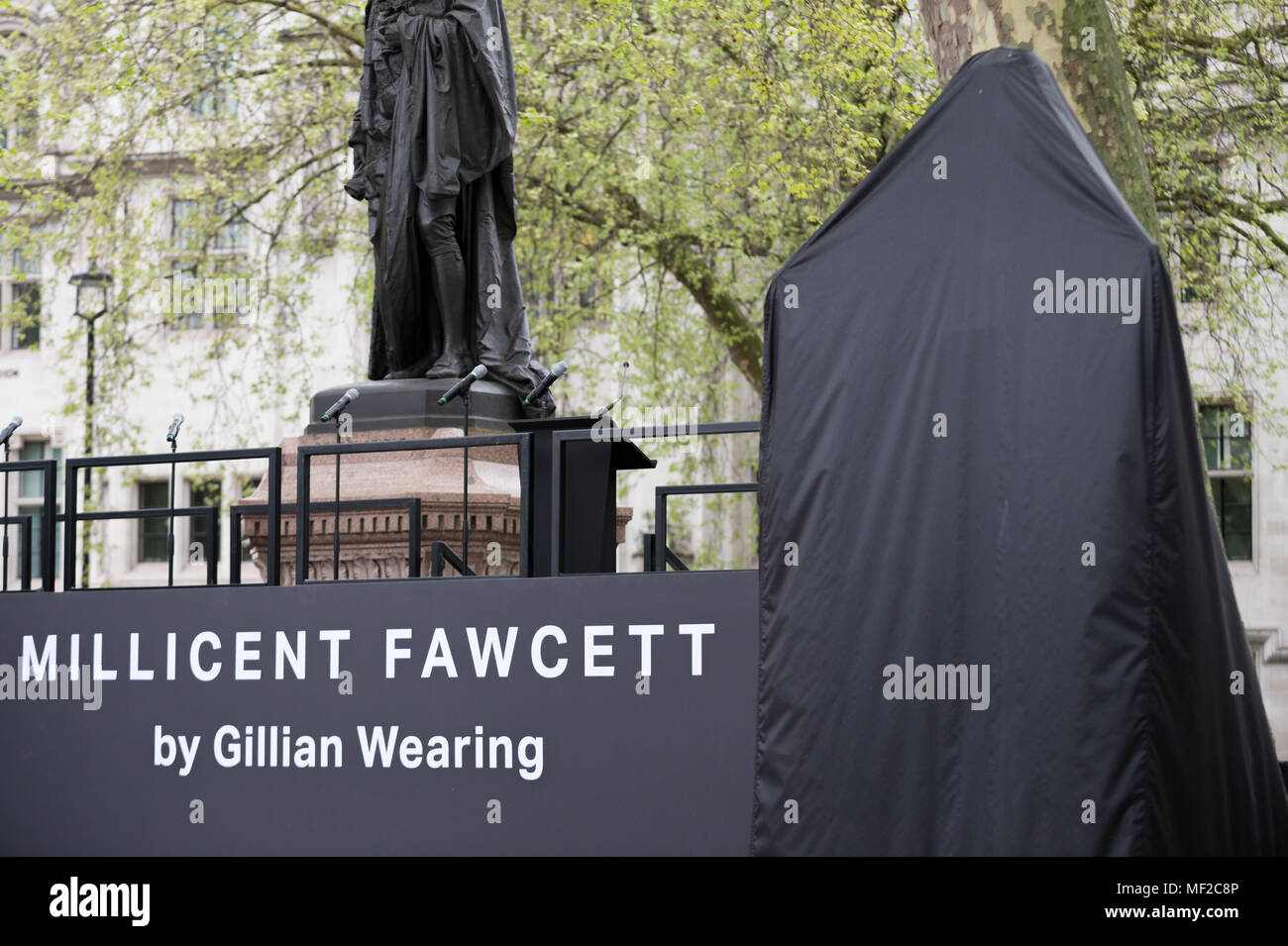 London, UK. 24th April, 2018. Statue of Millicent Fawcett stands veiled in Parliament Square just prior to the unveiling ceremony. The first statue of a woman in Parliament Square joins the line-up of male figures to mark the centenary of women’s suffrage in Britain - two years after the campaign to get female representation outside the Palace of Westminster began. Credit: Guy Corbishley/Alamy Live News Stock Photo