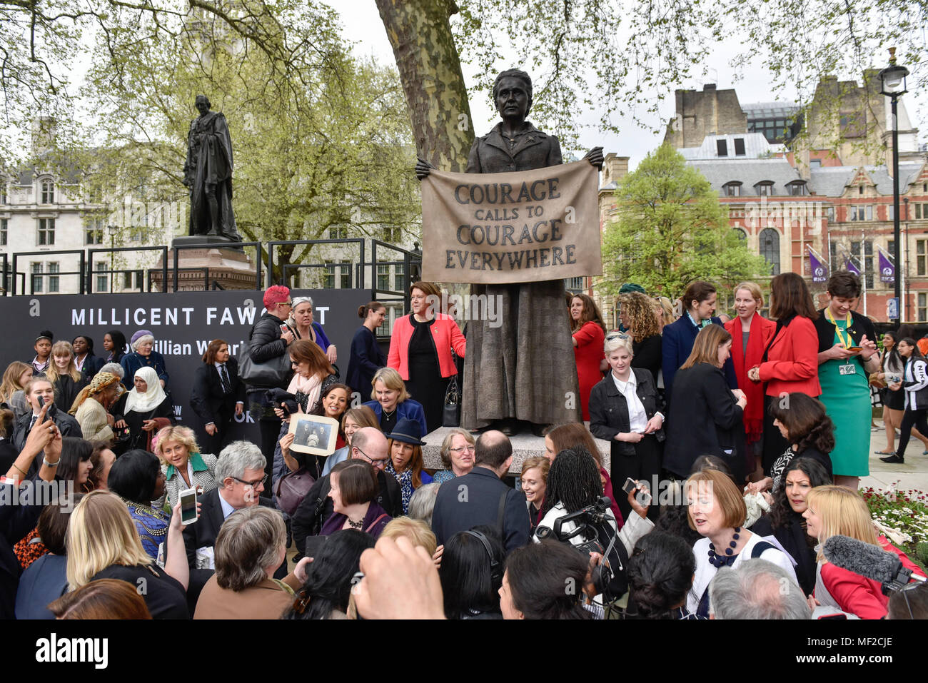 London, UK.  24 April 2018. Members of the audience take photos at the unveiling of a statue of suffragist Millicent Fawcett in Parliament Square.  The bronze casting, created by artist Gillian Wearing, shows a banner reading the text 'courage call to courage everywhere', is the first statue of a woman to be erected in Parliament Square and was commissioned as part of this year's centenary of the 1918 Representation of the People Act, giving some women aged over 30 the right to vote.  Credit: Stephen Chung / Alamy Live News Stock Photo