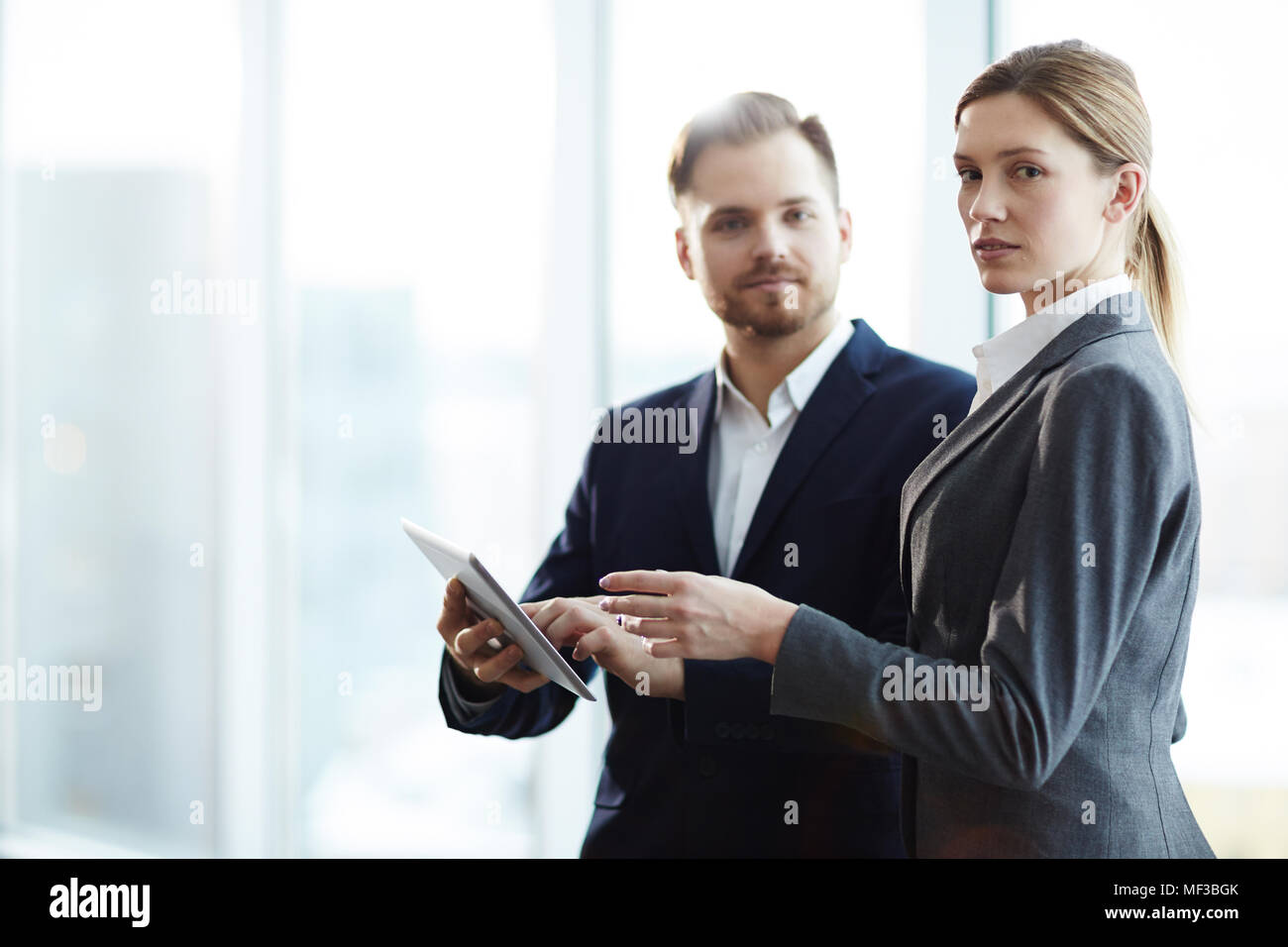 Portrait of young business people using digital tablet together for work Stock Photo