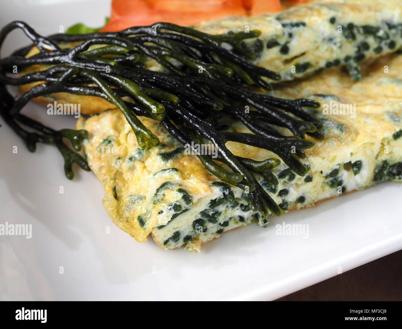 Codium – Velvet horn – Spongeweed cooked in Omelette.  Edible green seaweed in the family Codiaceae. Binomial name: Codium tomentosum. There are about Stock Photo