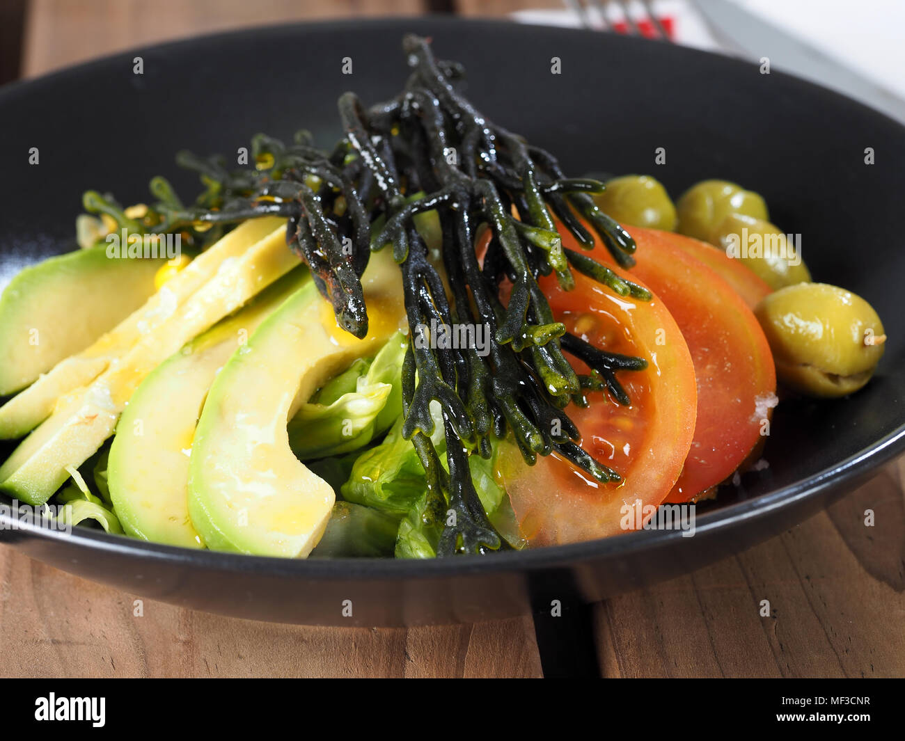 Codium – Velvet horn – Spongeweed in Salad with avocado.  Edible green seaweed in the family Codiaceae. Binomial name: Codium tomentosum. There are ab Stock Photo