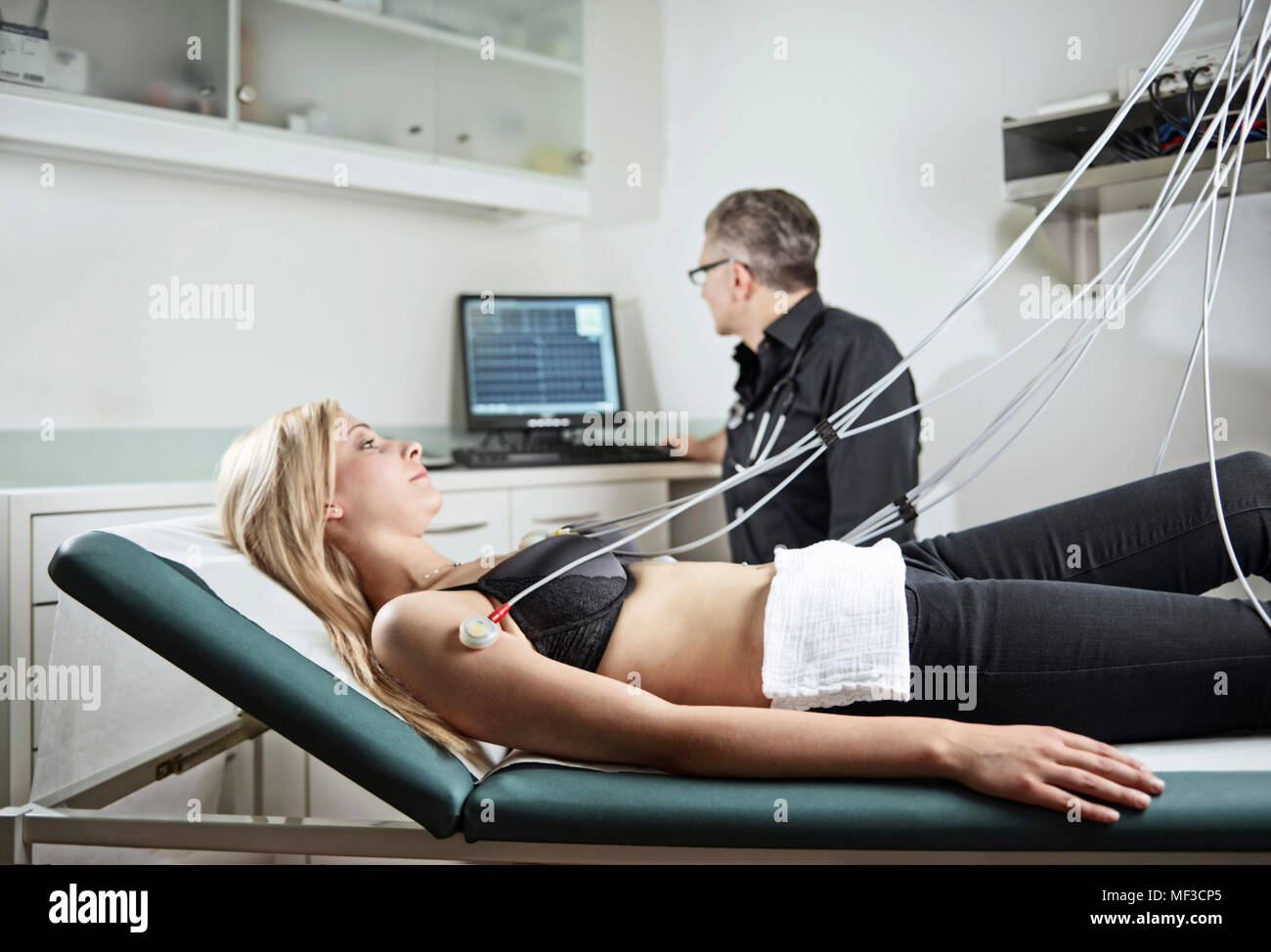 Woman in hospital getting heart rate monitored Stock Photo