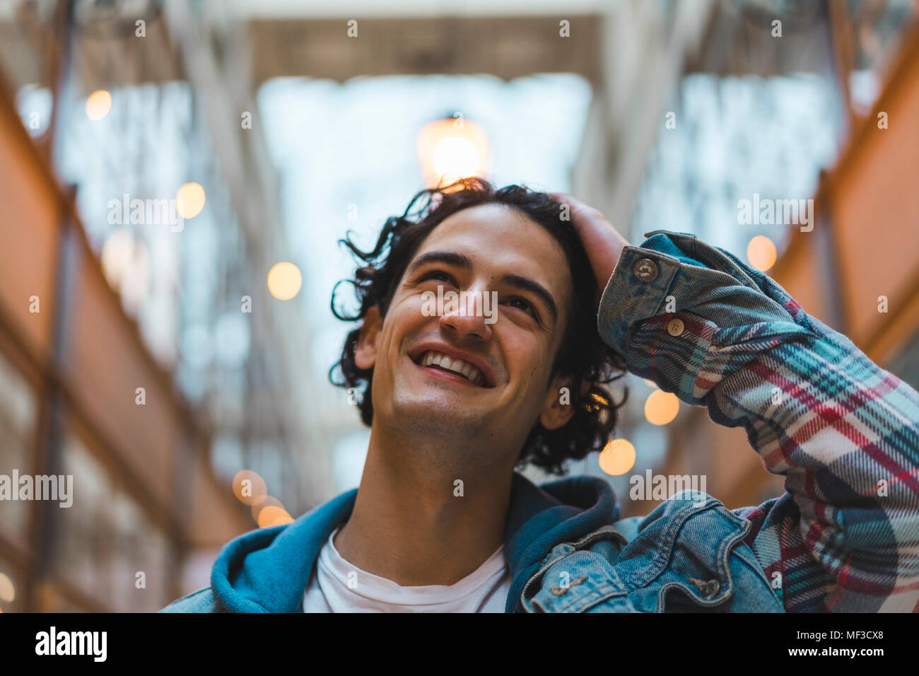 Portrait of smiling young man in shopping centre Stock Photo - Alamy