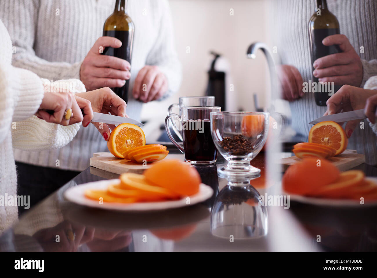 Woman slicing an orange for mulled wine Stock Photo