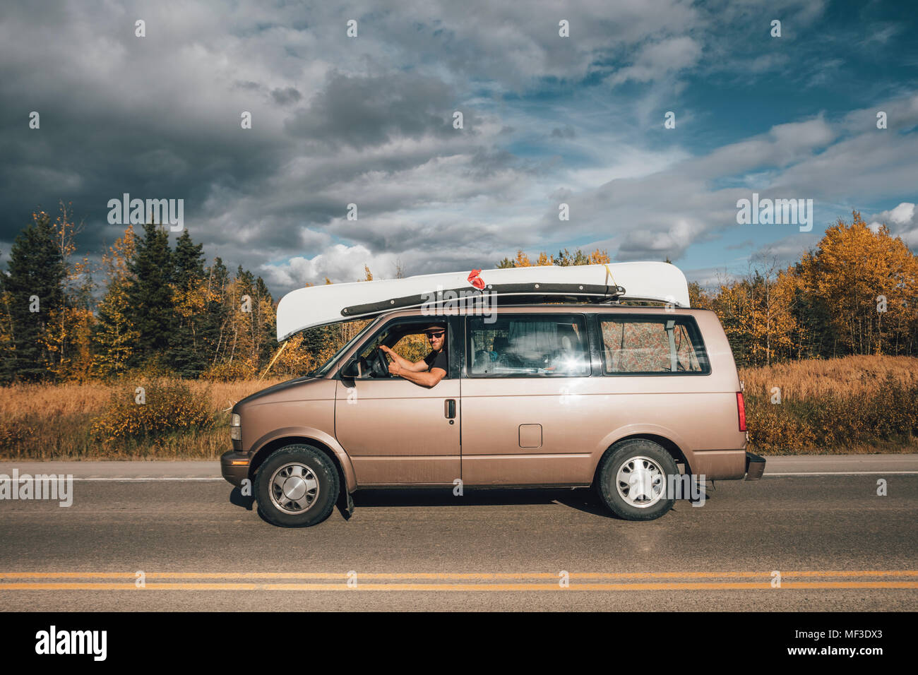 Canada, British Columbia, man with minivan on Alaska Highway Stock Photo