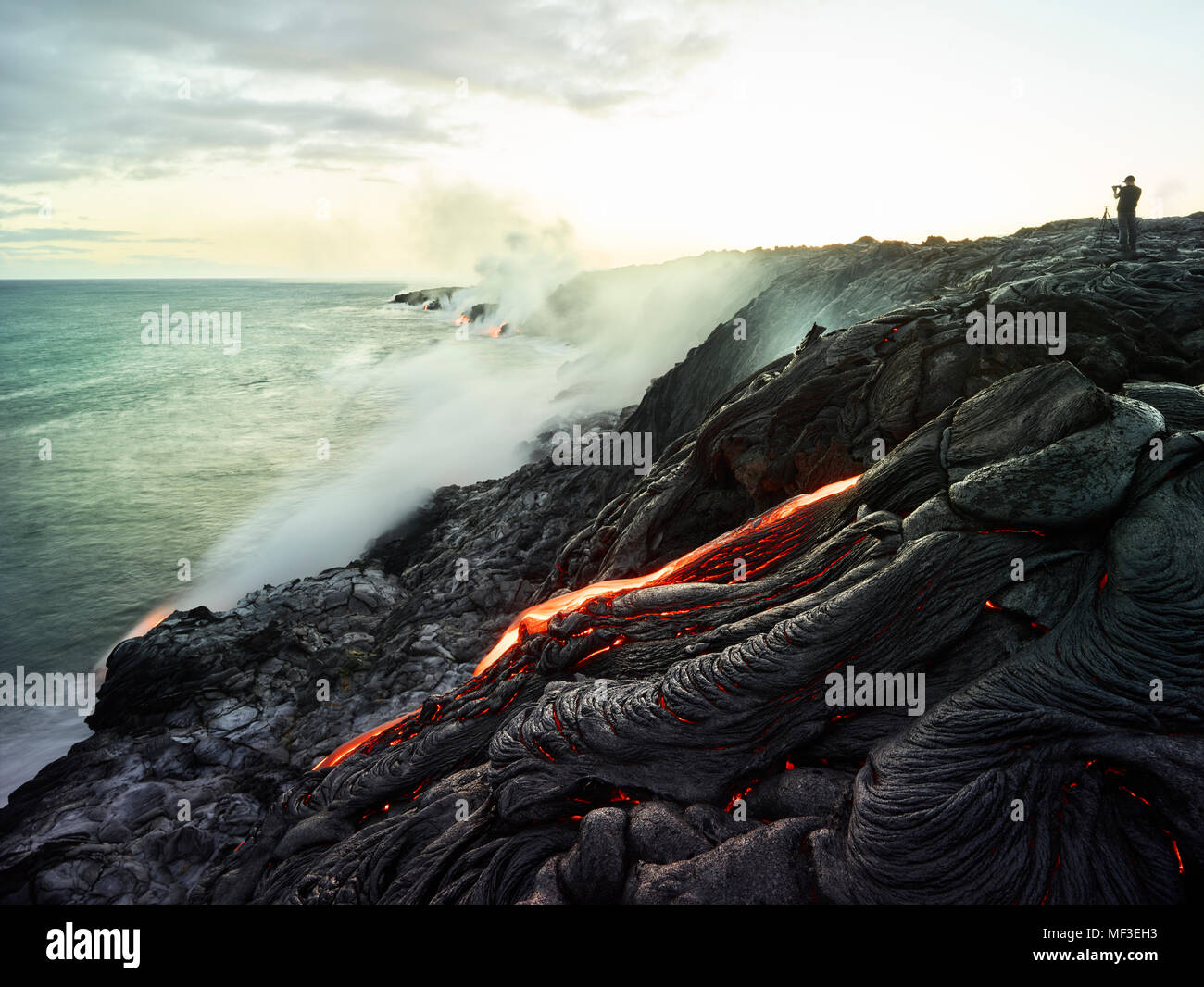 Hawaii, Big Island, Hawai'i Volcanoes National Park, lava flowing into pacific ocean, photographer Stock Photo