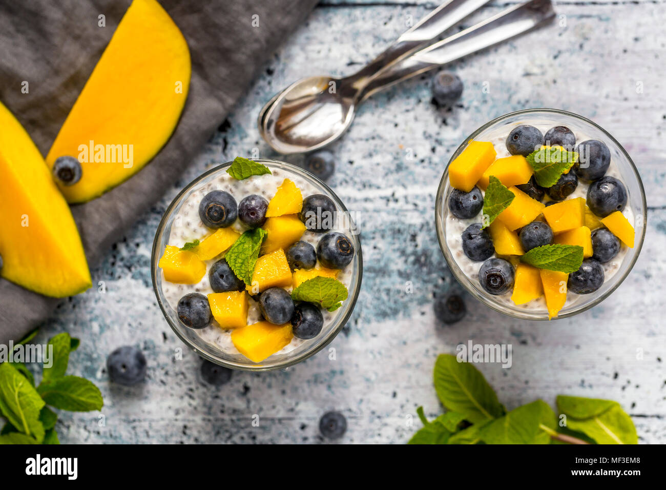Two glasses of chia pudding with mango and blueberry Stock Photo Alamy
