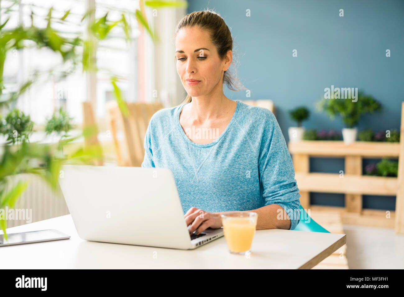 Woman sing laptop in her new flat Stock Photo