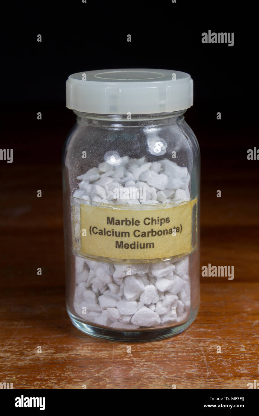 A jar of medium sized calcium carbonate (marble) chips as used in a UK secondary/high school. Stock Photo